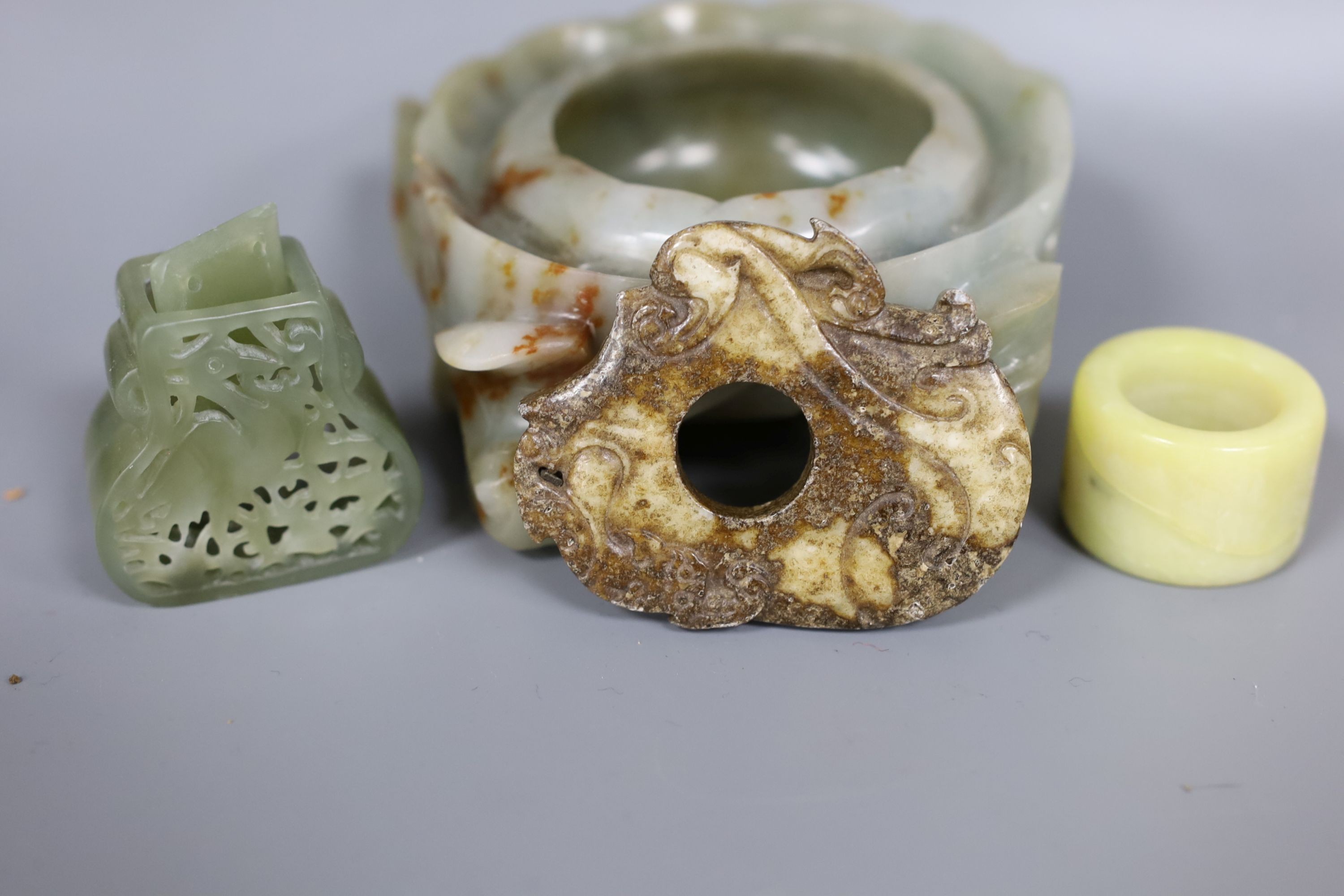 A Chinese jade brushwasher and three hardstone carvings